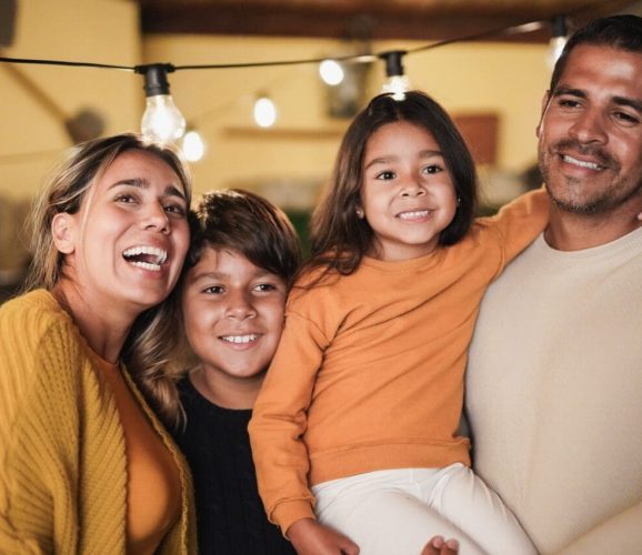 Happy latin family portrait at home on patio